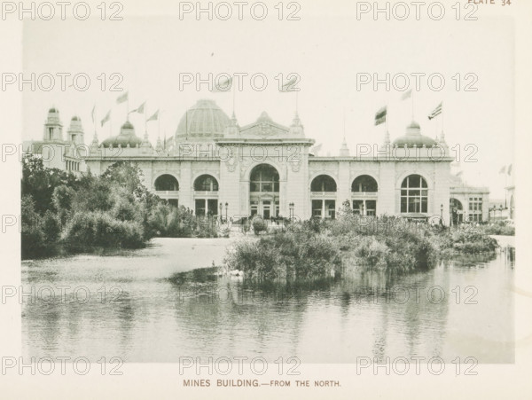 View of the building for mines and mining, designed by Solon Spencer Beman at the World's Columbian Exposition in Chicago in 1893, Mines Building.- From the north, page, photomechanical print, number: 'Plate 34', photographer: Charles Dudley Arnold, Chicago, photographer: HD Higinbotham, clichémaker: anonymous, 1893, Charles Dudley Arnold, HD Higinbotham, photographer, clichémaker, North America, Illinois, paper, collotype, photogravure, height 134 mm x width 191 mm, world fair, world exhibition, World's Columbian Exposition, A large classical building with a central dome and flanking smaller domes sits behind a body of water and dense shrubbery, showing a symmetrical façade with arched windows and ornate architectural detailing, flagpoles with flags flying atop the roofline, lamp posts and small groups of people visible near the entrance, and reflected ripples of the structure and vegetation in the calm water in the foreground.