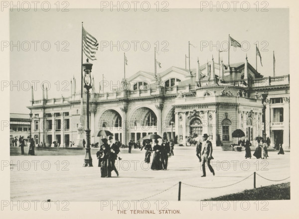 The terminal Station, View of the train station at the World's Columbian Exposition in Chicago in 1893, page, photomechanical print, number: 'Plate 36', photographer: Charles Dudley Arnold, Chicago, photographer: HD Higinbotham, cliché maker: anonymous, 1893, Charles Dudley Arnold, HD Higinbotham, photographer, cliché maker, North America, Illinois, paper, collotype, photoprint, height 132 mm x width 192 mm, station, shelter (railway, tramway), world fair, world exhibition, World's Columbian Exposition, A wide facade of a grand stone building with ornate arches, columns, balustrades, and sculptural decorations stretches across the scene, topped by decorative rooflines and several flagpoles flying flags; in front of the building a tall ornate lamp post stands near the center foreground while groups of people in period clothing and hats walk and gather across a broad open paved plaza, some carrying umbrellas and some conversing, with a low chain barrier and grassy edge visible along the ...