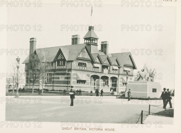 Great Britain, Victoria House, View of Victoria House, the Great Britain pavilion at the World's Columbian Exposition in Chicago in 1893, page, photomechanical print, number: 'Plate 71', photographer: Charles Dudley Arnold, Chicago, photographer: HD Higinbotham, clichémaker: anonymous, 1893, Charles Dudley Arnold, HD Higinbotham, photographer, clichémaker, North America, Illinois, paper, collotype, photogravure, height 133 mm x width 190 mm, world fair, world exhibition, World's Columbian Exposition, A large ornate building with patterned half-timbered upper walls and a steep tiled roof topped by a small tower with open arches and a flagpole sits behind a low fence and planted shrubbery, flanked by tall chimneys and a lamppost; in front of the building a raised stone pedestal supports a sculptural group of figures and animals, and several people in period clothing walk or stand on the paved foreground, one person blurred in motion near the center.