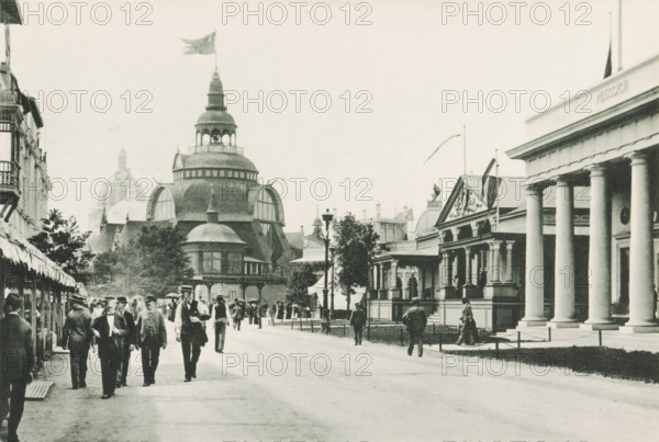 Government Buildings, Sweden, Hayti and New South Wales, Street with country pavilions at the World's Columbian Exposition in Chicago in 1893, page, photomechanical print, number: 'Plate 75', photographer: Charles Dudley Arnold, Chicago, photographer: HD Higinbotham, cliché maker: anonymous, 1893, Charles Dudley Arnold, HD Higinbotham, photographer, cliché maker, North America, Illinois, paper, collotype, photoprint, height 129 mm x width 191 mm, world fair, world exhibition, World's Columbian Exposition, A wide street scene shows a group of people walking toward the foreground, many wearing suits and hats, with a few holding umbrellas and some standing near storefronts on the left; the left side features a row of awnings and a tall building facade, while the center background is dominated by a large domed pavilion with rounded windows, layered roofs, and a flag flying from its highest point; to the right a neoclassical building with tall columns and a triangular pediment faces the str...