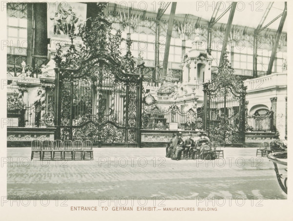 Entrance gates to the German exhibition during the World's Columbian Exposition in Chicago in 1893, Entrance to German exhibit.- Manufactures Building, page, photomechanical print, number: 'Plate 8', photographer: Charles Dudley Arnold, Chicago, photographer: HD Higinbotham, cliché maker: anonymous, 1893, Charles Dudley Arnold, HD Higinbotham, photographer, cliché maker, North America, Illinois, paper, collotype, photoprint, height 134 mm x width 190 mm, world fair, world exhibition, World's Columbian Exposition, An ornate wrought iron gate with intricate scrollwork and decorative motifs fills the midground, flanked by sculpted stone structures and architectural embellishments with carved figures and ornamental domes behind it, set within a large glass and iron exhibition hall whose framework and high windows are visible above; a row of wooden chairs is arranged in front of the gate on a patterned floor, and a small group of people in period clothing sit on chairs near the center, whil...
