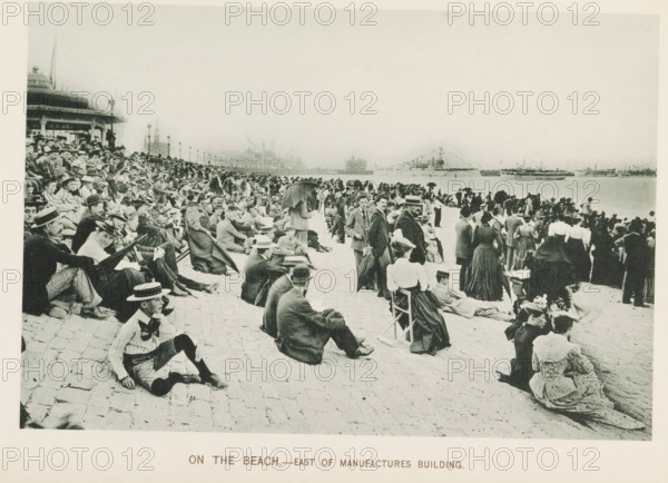 On the beach.- East of Manufactures Building, People watching ships from a quay during the World's Columbian Exposition in Chicago in 1893, page, photomechanical print, number: 'Plate 80', photographer: Charles Dudley Arnold, Chicago, photographer: HD Higinbotham, cliché maker: anonymous, 1893, Charles Dudley Arnold, HD Higinbotham, photographer, cliché maker, North America, Illinois, paper, collotype, photoprint, height 129 mm x width 191 mm, ships (in general), quay, world fair, world exhibition, World's Columbian Exposition, A wide beachfront scene shows a large crowd of people seated and standing along a paved shore facing the water, many wearing period clothing with hats, suits, long dresses, and coats; some individuals are seated on folding chairs or the pavement while others stand in small groups or lean on umbrellas, and a few hold parasols; in the background there are buildings and lamp posts along a promenade and ships visible on the water, including a decorated vessel with f...