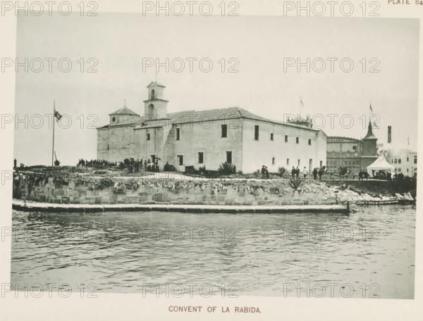 Convent of la Rabida, Pavilion of Spain at the World's Columbian Exposition in Chicago in 1893, page, photomechanical print, The pavilion was a copy of the Convento de Santa María de la Rábidaen and now serves as a children's hospital., number: 'Plate 84', photographer: Charles Dudley Arnold, Chicago, photographer: HD Higinbotham, clichémaker: anonymous, 1893, North America, Illinois, paper, collotype, photoprint, height 133 mm x width 191 mm, world fair, world exhibition, World's Columbian Exposition, A waterfront scene showing a large rectangular stone building with a tiled roof and a small bell tower, set behind a low stone seawall with plants along its top edge, people gathered near entrances and along the wall, a tall flagpole with a flag, a tented canopy and additional smaller structures visible near the building, and rippling water in the foreground.