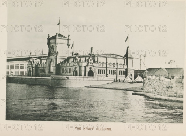 The Krupp Building, Pavilion of the Krupp company with weapons at the World's Columbian Exposition in Chicago in 1893, page, photomechanical print, number: 'Plate 87', photographer: Charles Dudley Arnold, Chicago, photographer: HD Higinbotham, cliché maker: anonymous, 1893, Charles Dudley Arnold, HD Higinbotham, photographer, cliché maker, North America, Illinois, paper, collotype, photoprint, height 133 mm x width 191 mm, world fair, world exhibition, World's Columbian Exposition, A large ornate waterfront building with decorative towers and arched entrances sits behind a stone quay, with a tall central tower topped by a flagpole and sculptural details along the roofline; a curved facade section bears a rounded windowed upper area and a flagpole on a secondary tower, while tents and small structures are visible near the water's edge and a low stone wall extends into the foreground along the shoreline, all reflected in rippling water under a pale sky.