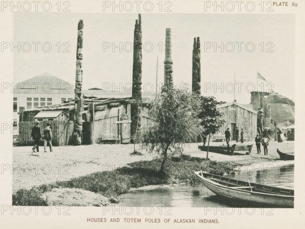 Houses and totem poles of Alaskan people at the World's Columbian Exposition in Chicago in 1893, Birchbark wigwams of Penobscot Indians, page, photomechanical print, number: 'Plate 89', photographer: Charles Dudley Arnold, Chicago, photographer: HD Higinbotham, cliché maker: anonymous, 1893, Charles Dudley Arnold, HD Higinbotham, photographer, cliché maker, North America, Illinois, paper, collotype, photoprint, height 131 mm x width 191 mm, world fair, world exhibition, World's Columbian Exposition, A waterfront scene shows a row of tall carved wooden poles rising behind a cluster of wooden buildings with plank walls and pitched roofs, a small tree and a larger bush in front of the buildings, a wooden canoe moored at the water's edge, several men in period clothing walking or standing near the buildings and along the shore, a low dock or bench area by the water, and a distant hillside with a flag on a pole.