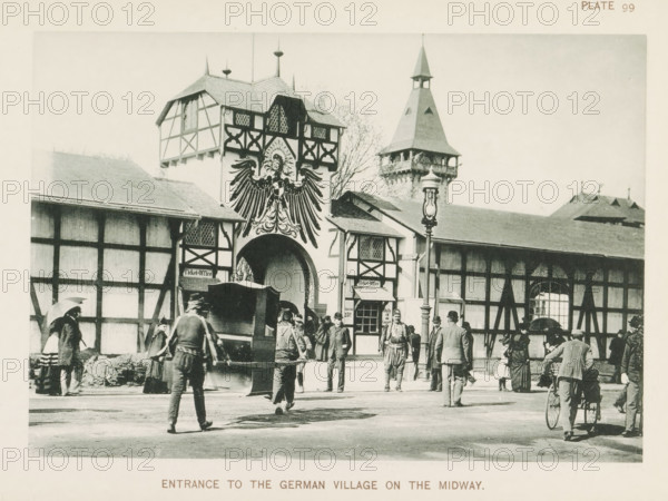 Entrance to the German Village on the Midway, Entrance to the World's Columbian Exposition in Chicago in 1893, page, photomechanical print, number: 'Plate 99', photographer: Charles Dudley Arnold, Chicago, photographer: HD Higinbotham, cliché maker: anonymous, 1893, Charles Dudley Arnold, HD Higinbotham, photographer, cliché maker, North America, Illinois, paper, collotype, photoprint, height 133 mm x width 191 mm, world fair, world exhibition, World's Columbian Exposition, A large timber-framed building with decorative half-timber patterns and a central arched entrance topped by a large painted eagle occupies the center of the scene, flanked by steep gabled roofs and a tall tower with a pointed roof visible behind it; a lamppost stands in front near the entrance. People in period clothing, including men in coats and hats, women with long skirts and some carrying umbrellas, and a few children, are gathered and walking in the foreground; one man is pushing an early bicycle with a large ...