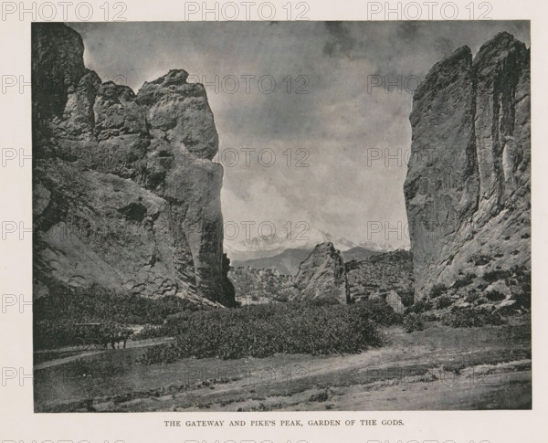 The gateway and Pike's Peak, Garden of the Gods, View of the rock formations of the Garden of the Gods and Pikes Peak, page, photomechanical print, Colorado Springs, cliché maker: New York Photo-Gravure Company, New York (city), c. 1888 - in or before 1893, New York Photo-Gravure Company, photographer, cliché maker, North America, Colorado, paper, autotypie, height 158 mm x width 202 mm, mountain-range, snow peaks, rock-formations, A black and white photograph showing a rocky landscape with two tall rock formations framing a central gap, rugged cliff faces with textured surfaces and vertical striations on either side, smaller rock outcrops and boulders in the middle distance, a flat plain with low vegetation and bushes in the foreground, a narrow dirt path winding through the scene, distant mountains visible through the gap under a cloudy sky, and a horse-drawn wagon on the path near the left rock face.