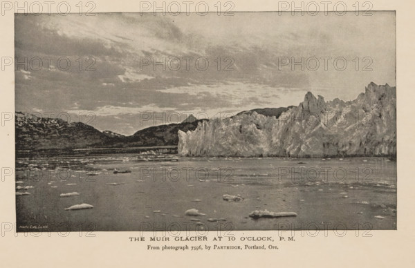 The Muir glacier at 10 o'clock, PM, View of the Muir Glacier, page, photomechanical print, inscription: 'From photograph 7596, by Partridge, Portland, Ore.', inscription: 'Photo-Eng Co. NY', photographer: William Henry Partridge, Skagway-Hoonah-Angoon, cliché maker: Photo-Engraving Co., New York (city), c. 1885 - in or before 1890, William Henry Partridge, Photo-Engraving Co., photographer, cliché maker, North America, Alaska, paper, autotypie, height 95 mm x width 165 mm, Print opposite table of contents., glacier, Muir Glacier, A wide seascape with a textured sky above a distant mountain range and a tall jagged ice cliff rising from the water, the foreground showing a calm surface dotted with irregular floating ice pieces and small icebergs, all rendered in a grainy monochrome tone.