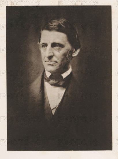 Portrait of Ralph Waldo Emerson, page, photomechanical print, cliché maker: anonymous, photographer: Southworth and Hawes Company, c. 1877 - in or before 1882, paper, collotype, photoprint, height 171 mm x width 125 mm, Print on fourth unnumbered page after page 27., Person, Ralph Waldo Emerson, historical persons, A sepia-toned portrait of a man shown from the chest up, wearing a dark jacket with a light-colored shirt and a dark bow tied at the collar, his hair combed neatly and parted to one side, a solemn facial expression with visible sideburns and gaze directed slightly to the side, surrounded by a dark vignetted background and a lighter border around the image.
