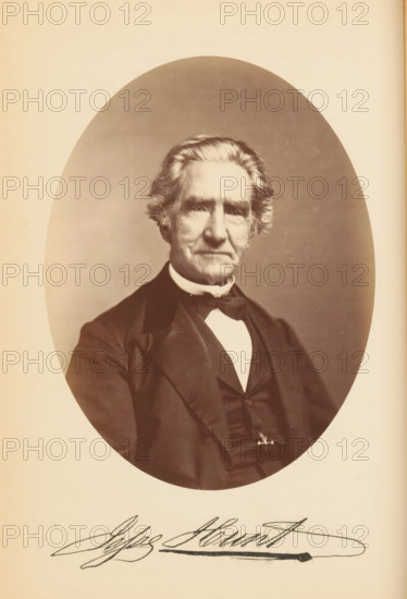 Jesse Hunt, Portrait of Jesse Hunt, photograph, page, photographer: Bendann Bros., c. 1866 - in or before 1871, paper, albumen print, height 148 mm x width 113 mm, Person, historical persons, A sepia-toned oval portrait of an older man shown from the chest up, with neatly combed hair swept back and sideburns, wearing a dark suit jacket, waistcoat, white shirt, and bow tie; the background inside the oval is plain and softly shaded, and the oval image is set against a lighter rectangular page with a large cursive signature visible below the portrait.