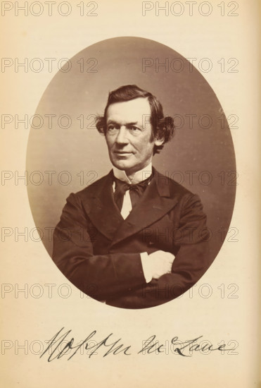 Portrait of Robert Milligan McLane, Robert M. McLane, photograph, page, photographer: Bendann Bros., c. 1866 - in or before 1871, paper, albumen print, height 148 mm x width 114 mm, Person, Robert Milligan McLane, historical persons, A sepia-toned oval portrait of a middle-aged man with neatly combed dark hair and curled sideburns, wearing a dark suit jacket, a high white collar, and a dark bow tied at the neck, shown from the torso up with arms crossed and a neutral facial expression, set against a plain background and surrounded by a light border.