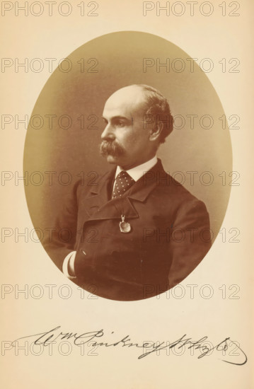 Portrait of William Pinkney Whyte, Wm. Pinkney Whyte, photograph, page, photographer: Bendann Bros., c. 1866 - in or before 1871, paper, albumen print, height 147 mm x width 114 mm, Person, William Pinkney Whyte, historical persons, A sepia-toned oval portrait of a man shown from the chest up, turned in three-quarter profile to his left, with a receding hairline and a thick mustache, wearing a dark double-breasted coat over a white shirt and a dotted tie, a round pendant hanging from a chain at his chest, his right arm bent with a visible cuff, set against a darker oval background framed by a lighter border.