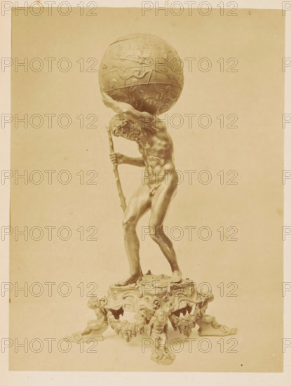 Silver Atlas figurine by one of the Van Vianen brothers, Silver Atlas figurine, crafted by van Vianen, photograph, page, number: 'No. 3359.', photographer: Pieter Oosterhuis, Amsterdam, 1876, paper, albumen print, height 167 mm x width 125 mm, Photo on fourth unnumbered page after page 204., piece of sculpture, reproduction of a piece of sculpture, Atlas supporting the heavens on his shoulders, Historical Exhibition Amsterdam, Oudemannenhuis (Amsterdam), Period, A sepia-toned photograph shows a tall sculpted male figure standing on an ornate base, the figure holding a staff and leaning forward as he supports a large decorative globe on his shoulders; the globe has raised relief designs and the man's muscular form, detailed facial hair, and defined limbs are visible, while the base beneath him features carved cherubic figures, scrollwork, and decorative garlands.