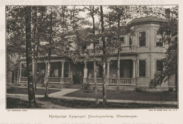 Methodist Episcopal Head-quarters, Chautauqau, View of the headquarters of the Methodist Episcopal Church in Chautauqau, New York, page, photomechanical print, photographer: Ch. Ehrmann, cliché maker: Moss Engraving Co. (possibly), c. 1884 - in or before 1889, printer (person), North America, paper, autotype, height 95 mm x width 159 mm, Print on third unnumbered page after page 328., organizations, assemblies, etc., episcopal Protestant churches, A large two-story wooden building with a wide covered porch extending across the front and decorative railings and columns, a corner bay with several windows, multiple tall trees in front partially obscuring the facade, shaded areas beneath the porch and around the trees, a lawn and a paved walkway leading to the porch steps, and a few people standing on the porch.