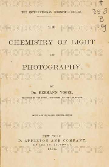The chemistry of light and photography, book, annotation: 'FEB 1982', bookplate: 'SFJ ex libris', writer (clerical worker): Hermann Wilhelm Vogel, publisher: D. Appleton and Company, New York (city), 1875, writer (clerical worker), North America, pasteboard, paper, textile materials, printing, wood engraving, galvanoplasty, photoaquatint, collotype, height 195 mm x width 135 mm x thickness 23 mm, A faded cream-colored book page with aged spots and discoloration, centered large serif title text across the top half, a horizontal rule near the top, smaller lines of serif text arranged vertically down the page, a vertical handwritten pencil mark and numerals near the upper right edge, and more serif text grouped toward the lower half above a blank lower margin.
