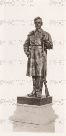 View of a detail of the civil war monument in Manchester, member of the infantry, page, photomechanical print, c. 1875 - in or before 1880, paper, collotype, photoprint, height 194 mm x width 91 mm, Print three pages after page 39., the soldier, the soldier's life, monument, statue, A full-length statue of a uniformed soldier standing on a multi-tiered pedestal, wearing a cap and a long coat with a belted waist, one hand resting on his hip and the other holding a rifle that stands upright beside him, with detailed facial features including a mustache, boots visible at the base of the coat, and the pedestal showing carved circular motifs and layered molding.