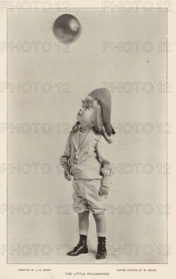 The little philosopher, page, photomechanical print, photographer: JA Brush, cliché maker: M. Wolfe, c. 1890 - in or before 1895, paper, autotypie, height 181 mm x width 113 mm, child, (flying a) gas balloon, A young child stands facing slightly sideways, wearing a loose long-sleeved top with a decorative element at the front, knee-length baggy shorts, and lace-up boots with socks; the child has shoulder-length wavy hair and wears a floppy hat tilted back while looking upward toward a round balloon floating above, against a plain light background.