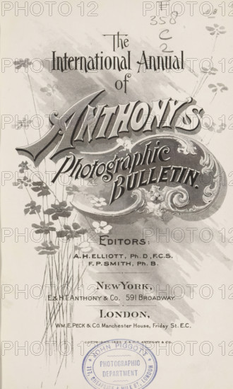 The international annual of Anthony's photographic bulletin, book, inscription: 'John Piggot Photographic department 117, Cheapside & milk St., London', editor (person who revises): Arthur H. Elliott, editor (person who revises): Francis P. Smith, publisher: E. & HT Anthony & Co., New York (city), publisher: WME Peck and Co., London, 1893 - 1895, Arthur H. Elliott, Francis P. Smith, E. & HT Anthony & Co., WME Peck and Co., editor (person who revises), publisher, North America, textile materials, pasteboard, paper, linen (material), printing, autotype, daylight gelatin silver print, photoaquatint, collotype, height 223 mm x width 149 mm x thickness 36 mm, A vertical vintage printed cover with ornate decorative lettering and flourishes occupying the upper and middle areas, surrounded by stylized floral illustrations with tall thin stems and clustered small flowers, a shaded background wash behind the main title, a block of smaller printed lines toward the lower center, and a circular sta...