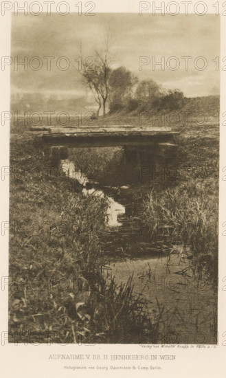Bridge over a ditch, page, photomechanical print, photographer: Hugo Henneberg, Vienna, cliché maker: Büxenstein & Comp., Georg, Berlin, printer (person): Wilhelm Knapp Verlag, Halle an der Saale, c. 1893 - in or before 1898, printer (person), Lower Austria, Saxony-Anhalt, paper, photoaquatint, height 177 mm x width 112 mm, Print after page 192., brook, bridge, A sepia-toned photograph shows a narrow stream bordered by tall grasses winding toward the foreground, a simple wooden footbridge spanning the stream near the middle of the image, and a cluster of leafless and sparse trees on a low rise in the background beneath a cloudy sky.