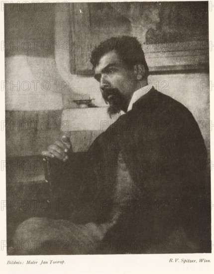 Bildnis: Maler Jan Toorop, Portrait of Jan Toorop, page, photomechanical print, monogram: 'LEIPZIG, S G', photographer: Friedrich Victor Spitzer, cliché maker: unknown, c. 1898 - in or before 1903, paper, autotypie, height 172 mm x width 140 mm, Person, Jan Toorop, historical persons, A monochrome portrait of a seated man shown from the side and slightly turned toward the viewer, with dark hair and a pointed beard, wearing a dark jacket and a light-colored collar, one hand resting on the arm of the chair and a relaxed posture, a framed rectangular object on the wall behind him and a light-toned rectangular surface at mid-height in the background, soft grainy texture across the image and a high-contrast tonal range.