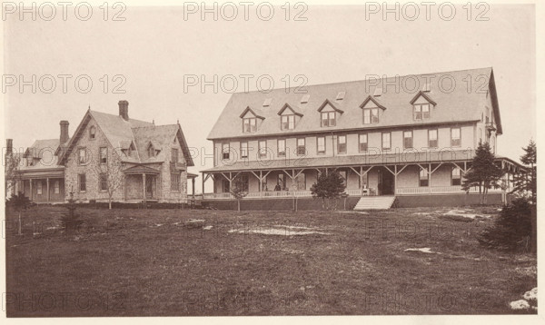 View of Samoset House on Mouse Island, Maine, Samoset House, Mouse Island, page, photomechanical print, c. 1875 - in or before 1880, North America, paper, collotype, photoprint, height 103 mm x width 176 mm, hotel, hostelry, inn, A wide sepia-toned photograph of two adjacent large buildings set on a grassy lawn, the building on the left having stone walls, steep gabled roofs with small dormer windows and multiple chimneys, and a covered porch along one side, while the building on the right is a long, three-story wooden structure with a steep roof punctuated by several dormer windows, a wraparound covered porch supported by posts and decorative brackets, a short flight of steps leading up to the porch, and small trees planted near the porch edge; the foreground shows a lawn with patches of bare ground and scattered small shrubs or young trees.