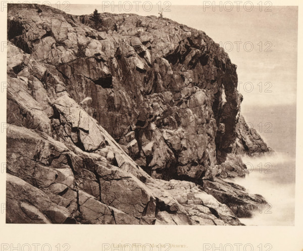 Great Head, Mount Desert, View of Great Head on Mount Desert Island, Maine, page, photomechanical print, c. 1875 - in or before 1880, North America, Mount Desert Island, paper, collotype, photoprint, height 131 mm x width 173 mm, cape (coast), A sepia-toned photograph showing a steep rocky cliff face with large angular boulders and fractured rock surfaces, textured cracks and crevices, sparse vegetation including a few small trees near the top, and waves or sea spray visible at the base where the cliff meets the water, with a pale sky occupying the upper right area.