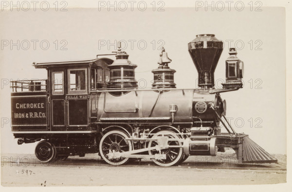 American steam locomotive, photograph, page, number: '597', United States of America, c. 1871 - in or before 1881, photographer, North America, paper, albumen print, height 125 mm x width 200 mm, Photo on page 128., steam locomotive, A sepia-toned side view of a vintage steam locomotive showing a cab with windows and a small railing, a cylindrical boiler with domed fittings and a tall tapered smokestack, a large headlamp mounted near the front, and a cowcatcher at the lower front; visible running gear includes large spoked driving wheels, connecting rods, and mechanical linkages; the locomotive has decorative trim and rivets, and there is a circular medallion-like plate on the boiler; the scene is framed against a plain light background and the train rests on rails with a ground surface beneath.