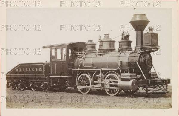 American steam locomotive, photograph, page, United States of America, c. 1871 - in or before 1881, photographer, North America, paper, albumen print, height 119 mm x width 197 mm, Photo on page 120., steam locomotive, A sepia-toned photograph of a steam locomotive shown from the side, featuring a rectangular cab with window openings, a cylindrical boiler with domed fixtures and pipes along its top and sides, large spoked driving wheels partially visible beneath the boiler, and a slanted pilot at the front. Behind the cab sits a coal tender with sloped sides and decorative trim. The front of the locomotive includes a tall, flared smokestack, a square lamp mounted on a bracket, a circular front plate on the smokebox, and a series of external valves, rods, and cylindrical tanks near the wheels. The train rests on a dirt surface within a plain, light background and the photo has a light-colored border around it.