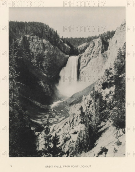 Great falls, from point lookout, page, photomechanical print, photographer: Frank Jay Haynes, Yellowstone National Park, cliché maker: The Photo-gravure Co., New York (city), c. 1886 - in or before 1891, North America, paper, collotype, photoprint, height 215 mm x width 165 mm, waterfall, Lower Yellowstone Falls, A tall waterfall drops between steep rocky cliffs into a misty plunge pool with a river flowing away through a narrow, rugged canyon; the cliff faces show textured rock and scattered trees, with denser forest visible along the canyon rim and a few bare tree trunks in the foreground.