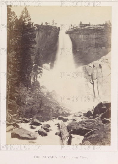 The Nevada Fall near View, View of the Nevada Falls in the Yosemite Valley, photograph, page, number: 'XVIII.', photographer: Carleton E. Watkins, Yosemite Valley, c. 1860 - in or before 1868, North America, California, paper, albumen print, height 206 mm x width 155 mm, waterfall, mountains, rock-formations, dale, valley, Nevadawaterval, A tall waterfall plunges between steep rocky cliffs, creating a misty plume that flows down into a boulder-strewn riverbed; dense evergreen trees line the left side of the scene and clinging trees dot the cliff tops, while large rounded rocks and a fallen log lie in the foreground among the flowing water.