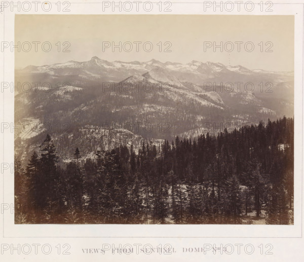 View of the Yosemite Valley from Sentinel Dome, Views from Sentinel Dome No. 3, photograph, page, number: 'XXI.', photographer: Carleton E. Watkins, Yosemite Valley, c. 1860 - in or before 1868, North America, California, paper, albumen print, height 155 mm x width 207 mm, mountains, rock-formations, dale, valley, A wide, sepia-toned landscape photograph showing layered mountain ridges receding into the distance under a pale sky, with snow patches on higher slopes and darker tree-covered lower slopes; the foreground contains a dense forest of tall conifer trees with snow on branches and a textured, uneven ground; midground domes and rounded granite outcrops rise above the tree line, and distant jagged peaks with snow traces form a horizon line.