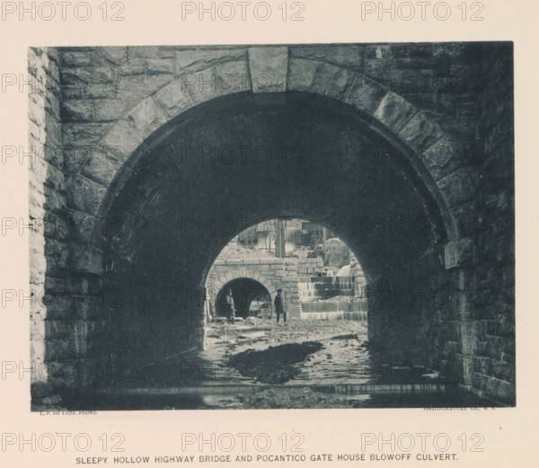 Sleepy Hollow Highway Bridge and Pocantico Gate House blowoff culvert, page, photomechanical print, photographer: P. de Luze, New York, cliché maker: The Photo-gravure Co., c. 1883 - in or before 1887, North America, paper, collotype, photoprint, height 153 mm x width 202 mm, bridge, A dark stone archway frames a view of another smaller stone arch and a cascading stepped water feature, with rough stone walls on either side and a shallow streambed leading inward; two figures stand near the inner arch, one holding a long object, and nearby are scattered stones and construction materials with timber scaffolding visible above the cascade.