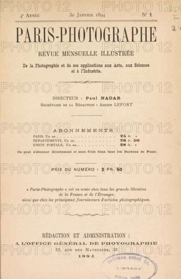 Paris-Photographe, magazine, editor (person who revises): Paul Nadar, 1894, editor (person who revises), pasteboard, biological material, paper, leather, photoaquatint, autotype, printing, collotype, height 273 mm x width 185 mm x thickness 50 mm, A yellowed printed page with a large centered title near the top in bold uppercase serif type, followed by several lines of smaller serif headings and centered lines, decorative horizontal rules, and blocks of printed text arranged in a formal layout; the paper shows slight age spots and a vertical crease, and a round blue oval stamp with faded ink appears near the lower right edge overlapping the bottom area.