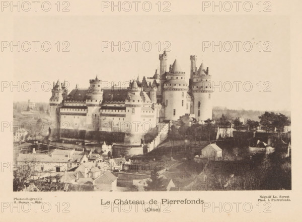 View of the Castle of Pierrefonds, Le Château de Pierrefonds, page, photomechanical print, photographer: Ls. Sorret, maker: H. Besson, c. 1887 - in or before 1892, paper, collotype, photoprint, height 104 mm x width 165 mm, landscape with tower or castle, castle, Pierrefonds, A large stone castle with multiple round towers and conical roofs sits on a raised mound above a cluster of small buildings and trees, showing fortified walls with battlements and rows of windows; steep stair-like pathways and terraces lead up to the castle, while rooftops of nearby houses and patches of open land surround the foreground, and a pale sky fills the upper area of the image.
