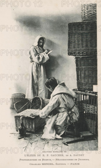 Two monks with wicker baskets and a bottle, page, photomechanical print, inscription: 'Gravure extraite de l'élixir du RP Gaucher, de A. Daudet', photographer: Henri Magron, cliché maker: Dujardin, publisher: Charles Mendel, c. 1890 - in or before 1895, Henri Magron, Dujardin, Charles Mendel, photographer, cliché maker, publisher, paper, photoaquatint, height 176 mm x width 105 mm, monk(s), friar(s), container made of plant material other than wood: basket, A monochrome scene shows two hooded figures in long robes among woven baskets and wicker structures; one figure stands holding an open book and looking down while the other kneels or crouches with hands on a flat woven lid, facing slightly away. The kneeling figure has a tied cord around the waist and a small rounded container hanging at the hip. Scattered straw and a closed bottle rest on a wooden floor near the baskets, and tall stacked wicker panels rise beside the standing figure. The background is plain and softly shaded.