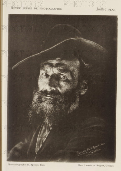 Portrait of an unknown man, page, photomechanical print, inscription: 'Revue Suisse de photographie, Juillet 1902', photographer: Lacroix fils & Rogeat, maker: Hans Speiser, c. 1897 - in or before 1902, paper, collotype, photoprint, height 154 mm x width 114 mm, historical persons, A black and white portrait of an older man wearing a wide-brimmed hat, shown from the chest upward, with a full beard and mustache, deep facial lines, and light reflecting in his eyes, set against a dark background.