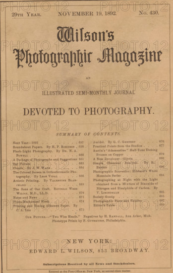 Wilson's photographic magazine, magazine, publisher: Edward Livingston Wilson, New York (city), 1892-11-19, Edward Livingston Wilson, publisher, North America, paper, printing, wood engraving, autotype, collotype, height 255 mm x width 177 mm x thickness 4 mm, A rectangular page with a tan background and a thin dark border containing a large ornate title in decorative black lettering near the top, a smaller centered line of text below it, a bold horizontal heading in large capital letters beneath that, and two columns of smaller printed lines and dot leaders filling the central area. The page shows faint smudges and aging marks, with a curved pencil or pen mark crossing part of the right column, and a thin horizontal rule separating sections. The lower portion displays centered lines of larger spaced lettering above an area of smaller printed lines and a narrow double-line border near the bottom. The overall appearance is of aged paper with printed typography in varying sizes and style...