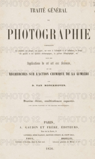 Traité général de photographie, book, inscription: 'Ma ... delapart del'Auteur D. van Monckhoven', publisher: A. Gaudin & frères, Paris, Brussels, 1856, A. Gaudin & frères, publisher, pasteboard, paper, printing, photoaquatint, veined marbled paper, agate marbled paper, height 235 mm x width 155 mm x thickness 33 mm, A vertically oriented aged paper sheet with a large bold headline across the upper half, smaller lines of printed text arranged in centered blocks below it, and decorative spacing between sections; the paper shows a mottled off-white color with light brown age spots and slight creases, and faint printed lines and ornamental lines separating some sections; the overall layout is symmetrical with varying font sizes and weights, and there is a small printed element near the bottom of the page.