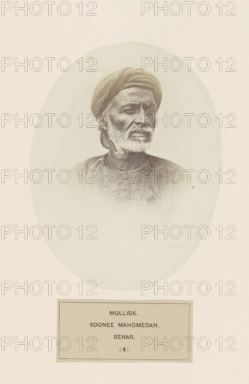 Portrait of an unknown man from the Malik clan of Bihar in eastern India, photograph, page, inscription: 'MULLICK., SOONEE MAHOMEDAN., BEHAR.', number: '(4)', Bihar, c. 1858 - in or before 1868, photographer, North India, paper, albumen print, height 158 mm x width 121 mm, human races, peoples, nationalities, A sepia-toned oval portrait of an older man with a turban and a trimmed white beard, shown from the shoulders up and turned slightly to one side, wearing a textured garment, centered on a pale background with a rectangular plaque visible beneath the oval.