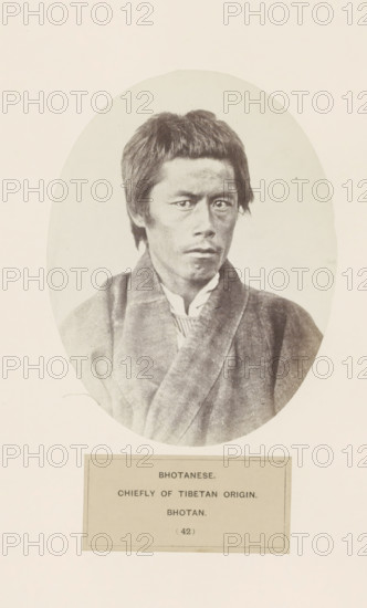 Portrait of an unknown man from Bhutan, photograph, page, inscription: 'BHOTANESE., CHIEFLY OF TIBETAN ORIGIN., BHOTAN.', number: '(42)', photographer: Benjamin Simpson (possibly), Bhutan, c. 1858 - in or before 1868, paper, albumen print, height 158 mm x width 121 mm, human races, peoples, nationalities, A sepia-toned oval portrait shows a man from the chest up facing slightly to his left with a neutral expression and short, straight hair; he wears layered clothing including a robe-like outer garment and a visible collar beneath, and the photograph is mounted on a pale background with a rectangular label area below the portrait.
