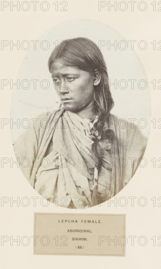 Portrait of an unknown woman from the Lepcha community of Sikkim, photograph, page, inscription: 'LEPCHA FEMALE., ABORIGINAL., SIKHIM.', number: '(48)', photographer: Benjamin Simpson (possibly), Sikkim, c. 1858 - in or before 1868, paper, albumen print, height 176 mm x width 130 mm, human races, peoples, nationalities, A monochrome oval portrait of a young woman shown from the torso up, facing slightly to her left with a downward gaze, her long dark hair parted and braided over one shoulder, wearing layered draped fabric and a visible necklace with a pendant, her expression appears neutral, and the portrait is mounted on a pale background with a rectangular label beneath the oval.