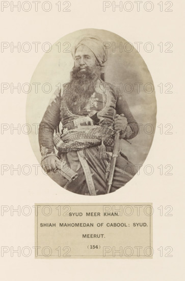 Portrait of Meer Khan from Meerut, Uttar Pradesh, India, photograph, page, number: '(154)', inscription: 'SYUD meer KHAN., SHIAH MAHOMEDAN OF CABOOL: SYUD., meerUT', Meerut, c. 1858 - in or before 1868, photographer, North India, paper, albumen print, height 120 mm x width 95 mm, head-gear: turban, human races, peoples, nationalities, An oval sepia photograph of a seated man wearing a turban and a long beard, dressed in ornate clothing with embroidered patterns and a decorative sash around his waist, holding a curved sword in one hand and a cylindrical object in the other, set against a plain light background with a rectangular bordered card below the portrait.