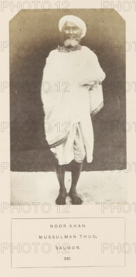 Portrait of Noor Khan, a thug who was imprisoned in Jabalpur, Madhya Pradesh, India, photograph, page, number: '361', inscription: 'NOOR KHAN., MUSSULMAN THUG., SAUGOR.', photographer: James John Waterhouse (possibly), Jabalpur, 1862, Central India, paper, albumen print, height 133 mm x width 80 mm, head-gear: turban, human races, peoples, nationalities, criminals, A full-length black-and-white portrait of an older man standing against a dark backdrop, wearing a light-colored turban and a draped garment that covers his torso and falls to his knees, with one arm folded under the drapery and the other resting at his side; he has a beard and moustache, bare lower legs and feet visible, and the image is framed with a pale border and a rectangular caption area below containing printed lines of text.