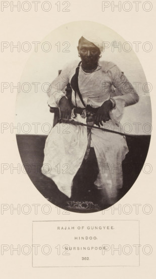 Portrait of an unknown raja in Narsinghpur, Madhya Pradesh, India, photograph, page, number: '362.', inscription: 'RAJAH OF GUNGYEE., HINDOO., NURSINGPOOR.', photographer: James John Waterhouse (possibly), Narsinghpur, 1862, Central India, paper, albumen print, height 139 mm x width 100 mm, ruler, sovereign, head-gear: turban, human races, peoples, nationalities, An oval-framed black-and-white photograph shows a seated person wearing a light-colored turban and layered clothing with long sleeves, a dark strap across the chest, and jewelry at the neck and ears; the person's hands rest on a long thin object held horizontally and the lower garments drape over the knees, with patterned footwear visible at the feet.