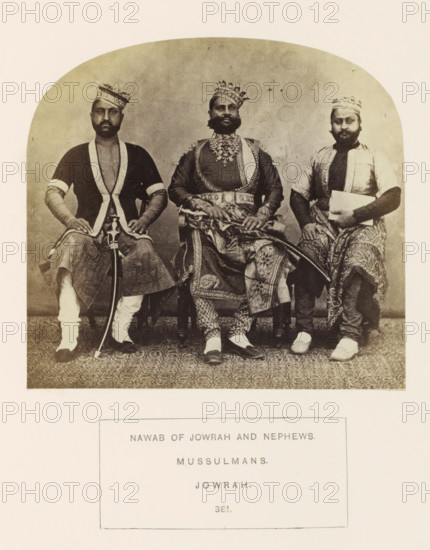 Portrait of Ghous Mahomed Khan, the Nawab of Jaora, with two nephews, Jaora, Madhya Pradesh, India, photograph, page, inscription: 'NAWAB OF JOWRAH AND NEPHEWS., MUSSULMANS., JOWRAH.', number: '381.', photographer: James John Waterhouse (possibly), 1862, Central India, paper, albumen print, height 110 mm x width 118 mm, ruler, sovereign, human races, peoples, nationalities, hacking and thrusting weapons (with NAME), Three seated men wearing patterned turbans and traditional garments occupy the framed photograph, with the central figure wearing ornate layered clothing and heavy jewelry and holding a decorated sword across his lap, while the two men on either side wear simpler tunics and patterned lower garments, one holding a curved sword upright and the other holding a rectangular object; all three have facial hair and neutral expressions, and the floor shows a patterned carpet beneath their feet.