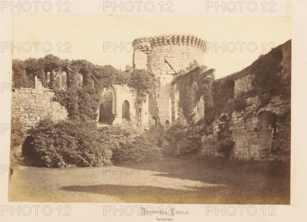 Bothwell Castle (interior), View of Bothwell Castle, photograph, page, South Lanarkshire, c. 1862 - in or before 1867, photographer, paper, albumen print, height 120 mm x width 179 mm, landscape with tower or castle, castle, A sepia-toned photograph of a stone castle interior showing a tall round tower with a crenellated top and a cylindrical stone face, flanked by ruined stone walls with arched openings and window-like recesses; portions of the walls are covered in dense ivy and climbing plants that cascade down and obscure sections of the masonry, while shrubs and bushes grow at the base of the ruins; a grassy foreground stretches toward the stone structures, and patches of shadow fall across the lawn.