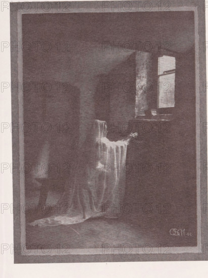 Portrait of an unknown woman depicted as a penitent, Büsserin, page, photomechanical print, inscription: 'Photographische Mitteilungen XL', photographer: Otto Scharf, Krefeld (possibly), cliché maker: anonymous, c. 1898 - in or before 1903, North Rhine-Westphalia, paper, autotypie, height 174 mm x width 129 mm, historical persons - BB - woman, A dim interior scene framed by a wide border shows a draped chair near a window, with light falling through the window onto a portion of the chair and floor; the chair is covered with a flowing, translucent fabric that cascades to the floor, creating soft folds and a small pooled area; a narrow table or ledge sits beneath the window with a few indistinct objects on it; the room beyond the chair is dark and shadowed, with a suggestion of other furniture shapes obscured by low light; the overall image has a grainy, monochromatic appearance.