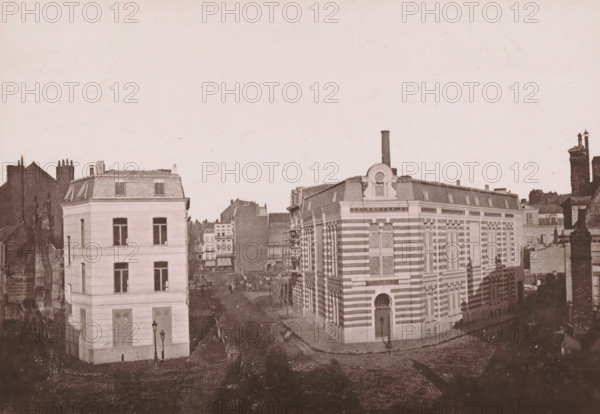 Le Hammam Lillois, View of the Rue Thiers and the bathhouse in the new part of Lille, Lille Nouveau, Aspect des Travaux du Cartier de l'Arc - La Rue Thiers, page, photomechanical print, inscription: 'Le Nord Contemporain, Revue Pittoresque', annotation: 'EF II', photographer: NC, Lille, cliché maker: Ferrand, c. 1877 - in or before 1882-11-15, NC, Ferrand, photographer, cliché maker, paper, collotype, photoprint, height 162 mm x width 234 mm, Print on fifth unnumbered page after page 336., street, public baths, A sepia-toned city street view showing multiple multi-story buildings with varied façades; on the left a light-colored rectangular building with tall windows and a mansard roof, adjacent to darker older structures, and on the right a larger ornate building with horizontal striping, tall arched windows with decorative grilles, and a central doorway topped by a curved decorative pediment and a chimney stack rising above the roof; a cobbled street curves between the buildings, with...