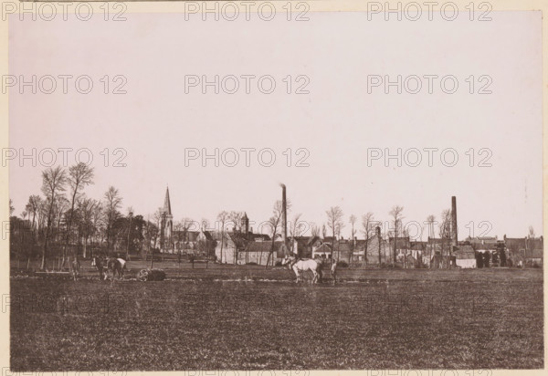 Un Paysage du Nord, Two farmers with horses working in the fields in Northern France, page, photomechanical print, inscription: 'Le Nord Contemporain, Revue Artistique & Pittoresque', photographer: NC, Northern France, cliché maker: C. Becquereau, Saint-Omer, c. 1877 - in or before 1882-12-31, paper, collotype, photoprint, height 159 mm x width 237 mm, Print on fifth unnumbered page after page 384., farmers, landscapes, horse, soil cultivation, A wide, sepia-toned landscape showing a large open field in the foreground with short grass, a few horses and people near the center and left edges, and a line of tall, leafless trees along the middle ground. Behind the trees a collection of buildings is visible, including a church with a pointed spire, other pitched-roof structures, and two tall vertical chimneys. The sky above is pale and mostly empty, occupying the upper portion of the image.