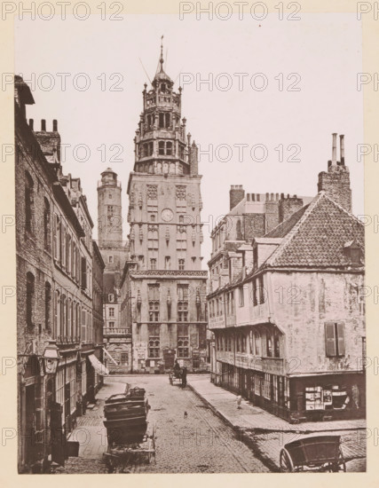 View of the Rue des Barricades and the bell tower of the Calais Town Hall, Calais, Le Beffroi & la Rue des Barricades, page, photomechanical print, inscription: 'Le Nord Contemporain, Revue Artistique & Archéologique', inscription: 'Journal le Nord Contemporain, No 28, année 1883.', photographer: NC, cliché maker: Neurdein Frères, c. 1878 - in or before 1883-03-05, paper, collotype, photoprint, height 226 mm x width 171 mm, Print on fifth unnumbered page after page 64., tower, clock tower, monumental adornment, A narrow cobbled street lined with multi-storey stone and brick buildings leads toward a tall ornate tower with multiple tiers, decorative windows, and a small dome at its peak, flanked by another cylindrical tower; the street shows parked wooden carts and a horse-drawn carriage, a few pedestrians, shuttered windows on the buildings, a tiled pitched roof on the right, chimneys rising above several rooftops, awnings and shopfronts at street level, and posters or notices affixed t...